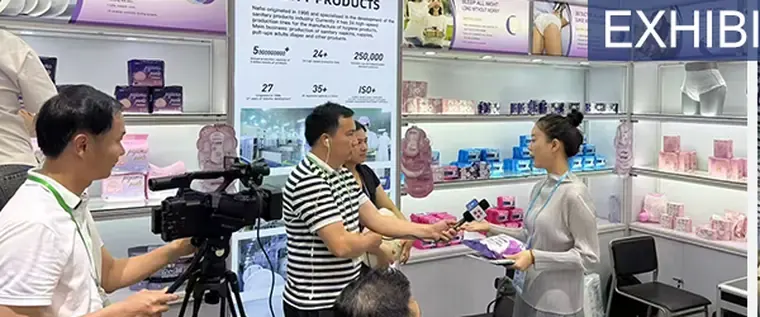 Conversation at a Nafei exhibition booth with hygiene products on display